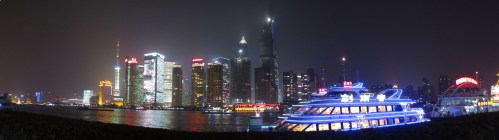 The tall, dark building in the center is the Shanghai Tower, under construction.